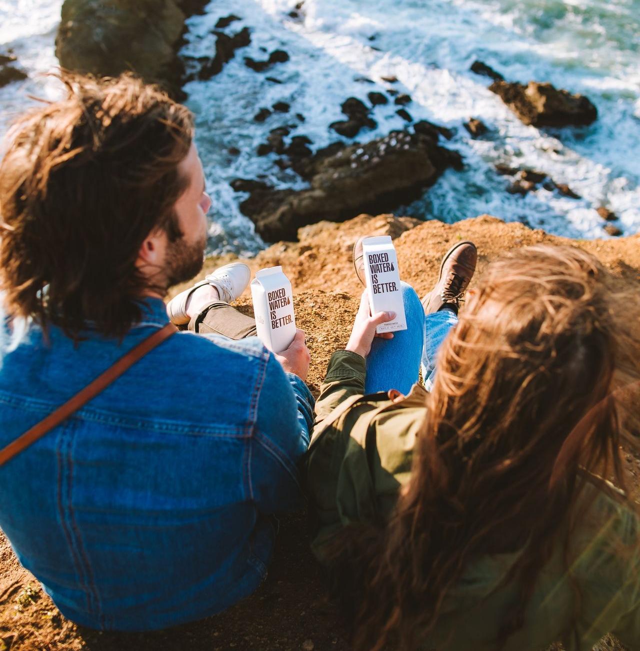 woman in blue denim jacket holding white smartphone